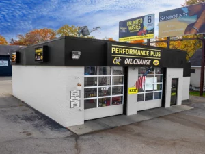 Black and white oil change building with two bay doors