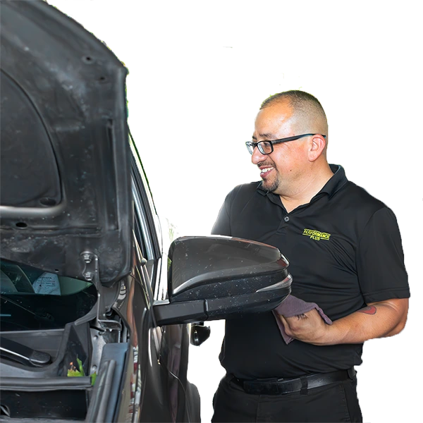 A Performance Plus oil change expert informing a customer about their vehicle's maintenance inspection